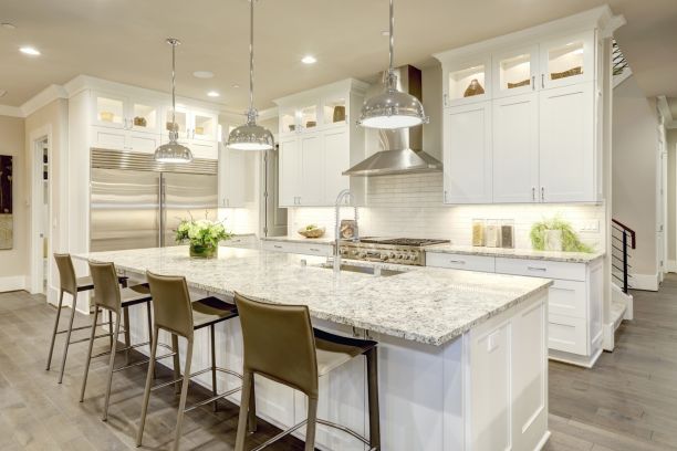 a white kitchen with an island