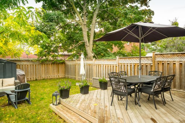 a deck and fence with a patio table